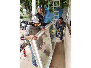 3 TC guys installing front window 1